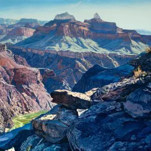Scenic view of a rocky canyon with a river flowing through it under a clear sky.