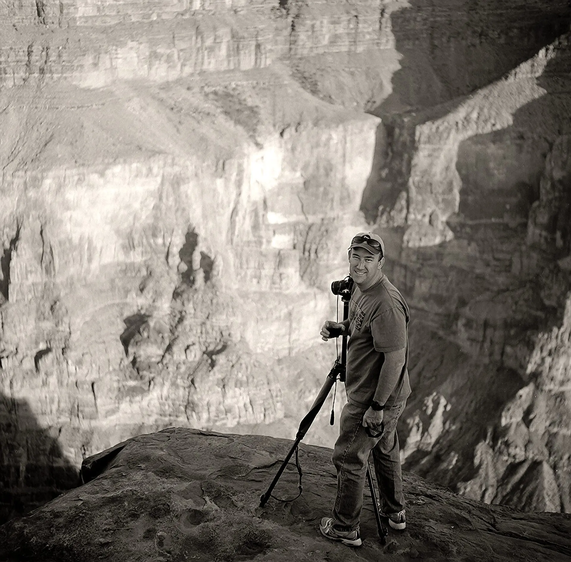 Photographer capturing a vast canyon landscape.